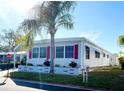 Side view of manufactured home showcasing landscaping at 3230 Banyan Ter, Sarasota, FL 34237