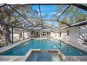 Large, refreshing pool and spa with a screened-in patio area at 3331 Old Oak Dr, Sarasota, FL 34239