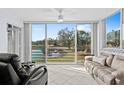 Bright sunroom with lake view and comfortable seating at 4440 Fairways Blvd # 206, Bradenton, FL 34209