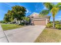 House exterior showcasing a driveway and landscaping at 4711 Garden Arbor Way, Bradenton, FL 34203