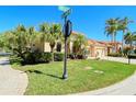 House exterior showing street view and lush landscaping at 5118 Chateau Ct, Sarasota, FL 34238