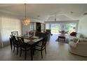 Open concept dining area with seating for six and access to the patio at 5449 Chanteclaire # 75, Sarasota, FL 34235