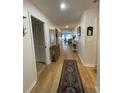 Light and bright entry hall with wood floors and view to living area at 5449 Chanteclaire # 75, Sarasota, FL 34235