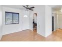 Bright entryway with wood floors, white walls, and kitchen peek at 5907 Todd St # E36, Bradenton, FL 34207