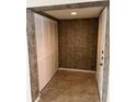 Bright condo entryway with tiled floor, coat closet, and textured walls at 6038 Red Maple Rd # 1003, Bradenton, FL 34210