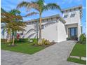 Modern home exterior with palm trees and landscaping at 6039 Salt Grass St, Bradenton, FL 34210