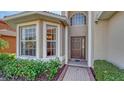 Front entrance with a bay window and a dark brown door at 6920 74Th Street E Cir, Bradenton, FL 34203