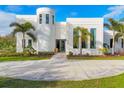 Modern white house with palm trees and circular driveway at 6939 Bee Ridge Rd, Sarasota, FL 34241