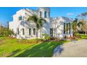 Contemporary home with circular driveway and lush landscaping at 6939 Bee Ridge Rd, Sarasota, FL 34241