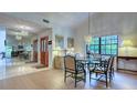 Bright dining room with glass table and wood floors at 7610 Fairway Woods Dr # 205, Sarasota, FL 34238