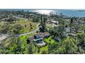 Stunning aerial shot showcases the backyard pool, manicured lawn, and nearby waterfront, creating a serene oasis at 7820 Seville Cir, Bradenton, FL 34209