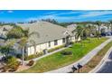 View of home's exterior showcasing a side yard and palm trees at 9367 Hawk Nest Ln, North Port, FL 34287