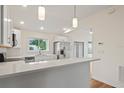 Modern kitchen with white cabinets, quartz countertops, and stainless steel appliances at 939 Cronley Pl, Sarasota, FL 34237