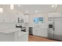 Modern kitchen featuring white shaker cabinets, quartz countertops, and stainless steel appliances at 939 Cronley Pl, Sarasota, FL 34237