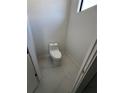 Simple, newly constructed powder room with white toilet and marble floor at 9493 St Paul Dr, Port Charlotte, FL 33981