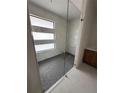 Modern shower with glass enclosure and hexagonal tile floor at 9493 St Paul Dr, Port Charlotte, FL 33981