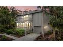 Two-story home with balcony, garage, and beautifully lit at night at 1444 Landings Cir # 72, Sarasota, FL 34231