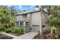 Two-story home with attached garage and walkway leading to the entrance at 1444 Landings Cir # 72, Sarasota, FL 34231