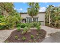 Two-story home with a gray facade and palm trees in the front yard at 1444 Landings Cir # 72, Sarasota, FL 34231