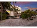 Modern home with a gated entry and beautifully landscaped front yard at 201 N Harbor Dr, Holmes Beach, FL 34217