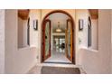 Elegant arched double front doors lead into the foyer with views of the bright interior at 279 Robin Dr, Sarasota, FL 34236
