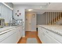 White kitchen with granite countertops and stainless steel appliances at 3206 Ramblewood N Dr # 18D, Sarasota, FL 34237