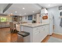 Bright kitchen with granite countertops and white cabinets at 3206 Ramblewood N Dr # 18D, Sarasota, FL 34237
