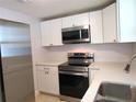 Modern kitchen features stainless steel appliances and white cabinets at 3301 Ash St, Punta Gorda, FL 33950