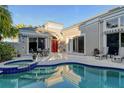 Resort-style backyard with a sparkling pool, patio seating, lush greenery, and a tranquil outdoor oasis at 3580 Fair Oaks Ln, Longboat Key, FL 34228