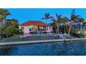 Beautiful waterfront property featuring a backyard pool, lush landscaping, and direct access to the water at 400 N Washington Dr, Sarasota, FL 34236