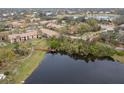 Aerial view of community with lake and walking paths at 4001 Crockers Lake Blvd # 11, Sarasota, FL 34238