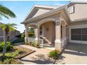 Front porch with arched entryway and white railings at 4153 Lenox Blvd, Venice, FL 34293