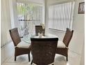 Bright dining area featuring a glass-top table and wicker chairs at 4515 45Th W Ave # 201A, Bradenton, FL 34210