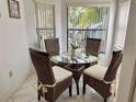 Cozy dining area with wicker chairs and a glass-top table at 4515 45Th W Ave # 201A, Bradenton, FL 34210