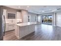 A kitchen with stainless steel appliances, a large island with a white countertop, and a dining area at 4739 Willow Bend Ave, Parrish, FL 34219