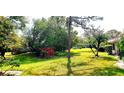 Landscaped backyard with lush greenery and mature trees, providing a serene outdoor space at 5244 Marsh Field Rd # 6, Sarasota, FL 34235