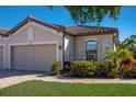 Charming single-Gathering home featuring a neutral color palette, paver driveway, and well-maintained landscaping at 5814 Cavano Dr, Sarasota, FL 34231