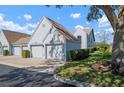 Exterior shot of townhomes showcasing attached garages, landscaping, and neutral color palette at 6609 Stone River Rd # 206, Bradenton, FL 34203
