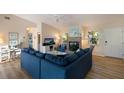 Spacious living area featuring a cozy fireplace and sectional sofa at 730 Holly Rd, Anna Maria, FL 34216