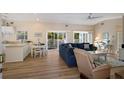 Bright living room with comfy seating and access to balcony at 730 Holly Rd, Anna Maria, FL 34216
