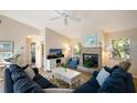 Open living space with sectional sofa, fireplace and view into kitchen at 730 Holly Rd, Anna Maria, FL 34216