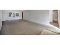 Large living room featuring neutral carpeting and lots of natural light at 7422 W Country Club N Dr, Sarasota, FL 34243