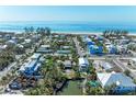 Coastal homes in a beach community offer seaside living in this bright aerial view at 9205 Gulf Dr, Anna Maria, FL 34216