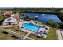 Community pool with lounge chairs and a gazebo overlooking a tranquil lake with a fountain at 1210 56Th W St # 1210, Bradenton, FL 34209