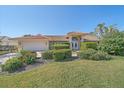 A charming single-story home with lush landscaping, a driveway, and a two-car garage at 1426 Landview Ln, Osprey, FL 34229