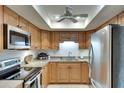 Well-equipped kitchen featuring stainless steel appliances and light wood cabinets at 1430 57Th W St # 1430, Bradenton, FL 34209