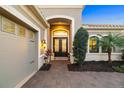 Elegant front entrance with a double door entry, neat landscaping, and a paver walkway at 15326 Castle Park Ter, Lakewood Ranch, FL 34202