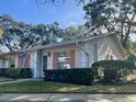 Side view of a single story home with a well maintained lawn at 1535 Nursery Rd # 107, Clearwater, FL 33756