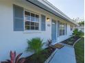 Freshly painted home with blue accents and walkway at 1752 Banyan Dr, Venice, FL 34293