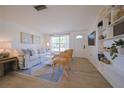 Bright living room with white sofa and built-in shelves at 1752 Banyan Dr, Venice, FL 34293